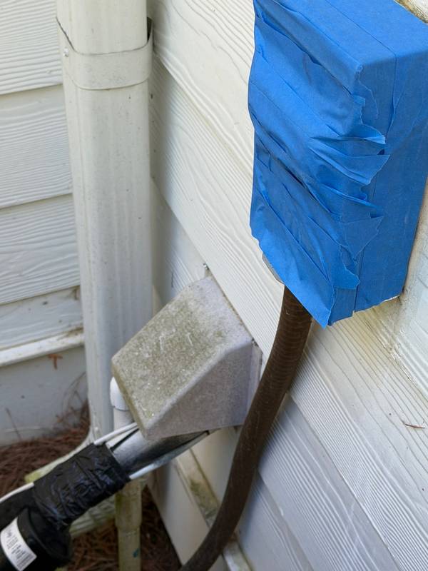 Exterior fixtures wrapped in plastic before soft wash to protect from water