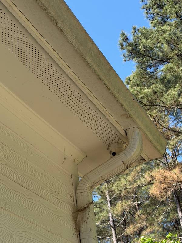 Gutter showing years of debris buildup before cleaning