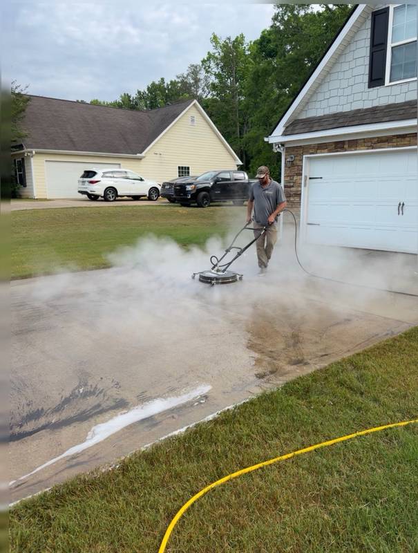 Piedmont Exterior hot water pressure washing with visible steam on a commercial surface