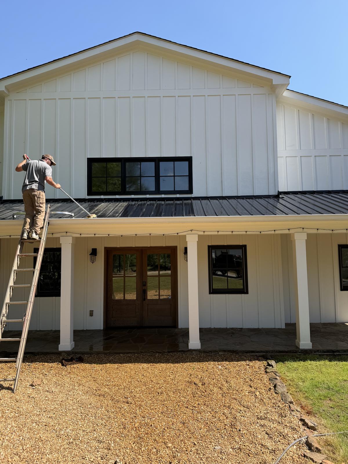 Piedmont Exterior cleaning pollen off a metal roof in North Georgia