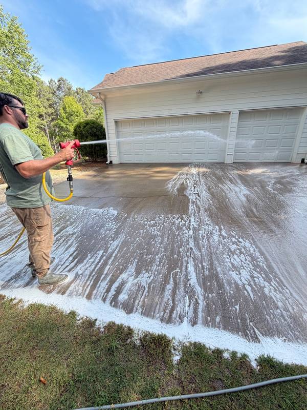 Pre-treatment foam application on driveway before pressure washing
