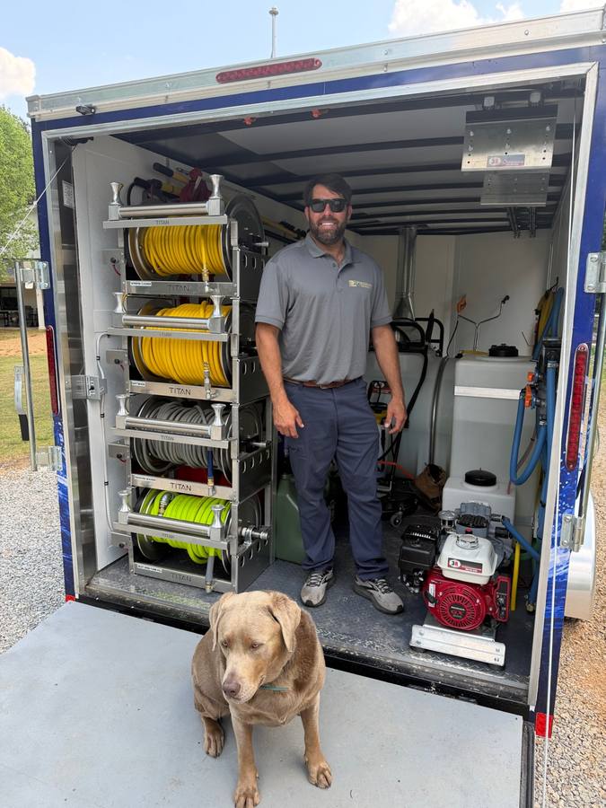 Trey Claus with organized equipment inside the Piedmont Exterior trailer